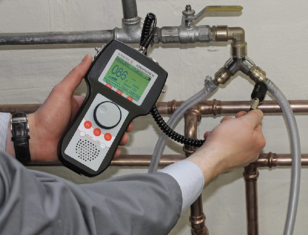 Plumber testing pipes with electronic leak detection equipment in Chambersburg