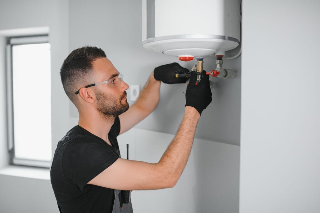 Technician performing water heater maintenance in Chambersburg